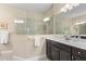 Elegant bathroom with a large glass-enclosed shower and a double vanity with dark cabinets at 2070 Crystal Lake Trl, Bradenton, FL 34211