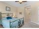 Inviting bedroom featuring a stylish bed frame and a glimpse into the hallway and bathroom at 2070 Crystal Lake Trl, Bradenton, FL 34211