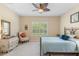 Comfortable bedroom features a decorative ceiling fan, shuttered windows, and plush carpeting at 2070 Crystal Lake Trl, Bradenton, FL 34211