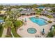 An aerial view of the large community pool, jacuzzi, outdoor seating and tables under shady pavilion at 2070 Crystal Lake Trl, Bradenton, FL 34211