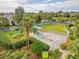 Aerial view of dog park with fenced areas, benches, and agility equipment surrounded by lush greenery at 2070 Crystal Lake Trl, Bradenton, FL 34211