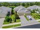 Aerial view of a well-manicured home with a three-car garage and beautiful landscaping at 2070 Crystal Lake Trl, Bradenton, FL 34211