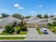 Aerial view of a well-manicured home with a three-car garage and beautiful landscaping at 2070 Crystal Lake Trl, Bradenton, FL 34211