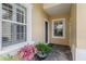 Inviting front porch area with decorative potted plants and stylish tile flooring at 2070 Crystal Lake Trl, Bradenton, FL 34211