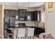 Well-equipped kitchen with dark cabinets, granite countertops, and modern stainless steel appliances at 2070 Crystal Lake Trl, Bradenton, FL 34211