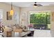 Bright living room featuring tile floors, a ceiling fan, and sliding glass doors to the lanai at 2070 Crystal Lake Trl, Bradenton, FL 34211