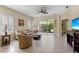 Inviting living room with tile flooring, comfortable seating, and a view of the lanai at 2070 Crystal Lake Trl, Bradenton, FL 34211