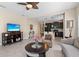 Open living room flows into a kitchen with dark wood cabinets, tile floors, and modern appliances at 2070 Crystal Lake Trl, Bradenton, FL 34211