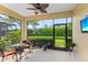 Relaxing screened patio with ceiling fan and outdoor seating overlooking the lush landscaping at 2070 Crystal Lake Trl, Bradenton, FL 34211
