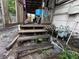 The wooden steps leading to a porch with cluttered debris and discarded items at 2230 50Th N Ave, St Petersburg, FL 33714