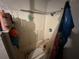 A soiled bathtub with stained walls, a hanging shower curtain, and assorted bath products at 2230 50Th N Ave, St Petersburg, FL 33714