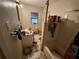 A small bathroom in disarray, with toiletries scattered around the sink and an untidy bathtub at 2230 50Th N Ave, St Petersburg, FL 33714