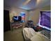 A cluttered bedroom with a TV, stained walls, and eclectic curtains at 2230 50Th N Ave, St Petersburg, FL 33714