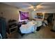 View of a cluttered bedroom with a ceiling fan and a purple curtain hanging in the window at 2230 50Th N Ave, St Petersburg, FL 33714