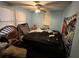 A messy bedroom with blue walls, a ceiling fan, and draped furniture at 2230 50Th N Ave, St Petersburg, FL 33714