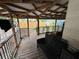 A wooden deck with an open view, furnished with a dark bench and a metal dog kennel at 2230 50Th N Ave, St Petersburg, FL 33714