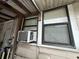 Close-up view of an exterior wall with an air conditioning unit installed below a window at 2230 50Th N Ave, St Petersburg, FL 33714