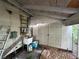 Interior view of the shed with an air conditioning unit, sink, and double doors at 2230 50Th N Ave, St Petersburg, FL 33714