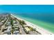 Beautiful aerial view showcasing the condo, beach, and Gulf of Mexico coastline and clear water at 2310 Gulf N Dr # 104, Bradenton Beach, FL 34217