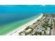 Stunning aerial shot of a beachfront condo with beach access and oceanfront views of clear blue water at 2310 Gulf N Dr # 104, Bradenton Beach, FL 34217