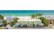Aerial view of the condo complex near the beach and turquoise water. Convenient parking is available at 2310 Gulf N Dr # 104, Bradenton Beach, FL 34217