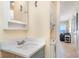Bathroom featuring sink, cabinet, and stacked washer/dryer with an ocean view from the living room at 2310 Gulf N Dr # 104, Bradenton Beach, FL 34217