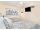 Comfortable bedroom with twin beds, calming decor, and a wall-mounted television at 2310 Gulf N Dr # 104, Bradenton Beach, FL 34217
