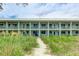 Condo exterior with beach access, balconies and a well-maintained lawn at 2310 Gulf N Dr # 104, Bradenton Beach, FL 34217