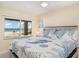 Relaxing main bedroom with a scenic view, king-size bed, and coastal-themed bedding at 2310 Gulf N Dr # 104, Bradenton Beach, FL 34217
