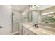 Elegant bathroom featuring double sinks, sleek black hardware, and a large glass-enclosed shower at 2321 Blue Mahoe Ln, Sarasota, FL 34240