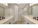 Luxurious bathroom with double sinks, white cabinets, modern fixtures, and a glass-enclosed shower at 2321 Blue Mahoe Ln, Sarasota, FL 34240