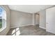 Well-lit bedroom features tile flooring, a large window, and a convenient closet for storage at 2321 Blue Mahoe Ln, Sarasota, FL 34240