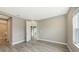 Spacious bedroom featuring wood-look tile flooring, neutral paint, and ensuite bathroom access at 2321 Blue Mahoe Ln, Sarasota, FL 34240