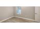 Cozy bedroom with a window letting in natural light and light wood-look flooring at 2321 Blue Mahoe Ln, Sarasota, FL 34240