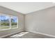 Cozy bedroom with tile flooring, and a large window providing natural light and scenic outdoor views at 2321 Blue Mahoe Ln, Sarasota, FL 34240