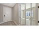 Inviting entryway with tile floors and glass door leading into a room filled with natural light at 2321 Blue Mahoe Ln, Sarasota, FL 34240