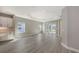 Open living room with wood-look tile, tray ceiling, and large windows offering plenty of natural light at 2321 Blue Mahoe Ln, Sarasota, FL 34240