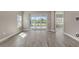 Bright living room showcasing tile flooring, neutral walls, and a sliding glass door leading to the lanai at 2321 Blue Mahoe Ln, Sarasota, FL 34240