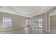 Spacious living room featuring tile flooring, recessed lighting, and a sliding glass door to the outdoor patio at 2321 Blue Mahoe Ln, Sarasota, FL 34240
