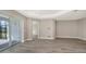 Well-lit living room with tile flooring, and multiple entryways to the rest of the open concept house at 2321 Blue Mahoe Ln, Sarasota, FL 34240