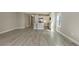 Open living area with tile flooring leading into a well-appointed kitchen with stainless steel appliances and white cabinetry at 2321 Blue Mahoe Ln, Sarasota, FL 34240