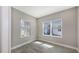 Bright office space featuring two windows, wood-look tile flooring, and neutral gray walls at 2321 Blue Mahoe Ln, Sarasota, FL 34240
