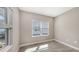 Bright office space featuring two windows, wood-look tile flooring, and neutral gray walls at 2321 Blue Mahoe Ln, Sarasota, FL 34240