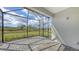 Screened lanai with brick-paved flooring and a stunning view of manicured landscaping at 2321 Blue Mahoe Ln, Sarasota, FL 34240