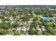 Extensive aerial view showcasing a residential area complete with tennis courts and swimming pool at 2558 Hawthorne St, Sarasota, FL 34239
