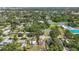 Wide aerial view of a neighborhood with tennis courts, a pool, and a nearby playground at 2558 Hawthorne St, Sarasota, FL 34239