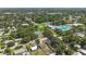 A sprawling neighborhood featuring a playground, pool, and tennis courts is captured from above at 2558 Hawthorne St, Sarasota, FL 34239