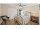 Cozy bedroom featuring a queen sized bed, bedside table, and an adjacent chair at 2639 Woodgate Ln # H8, Sarasota, FL 34231