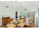 This light and airy dining room features tile floors and a modern chandelier at 2639 Woodgate Ln # H8, Sarasota, FL 34231