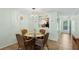 Inviting dining room with view to the kitchen, featuring a glass table, wicker chairs, and a stylish light fixture at 2639 Woodgate Ln # H8, Sarasota, FL 34231